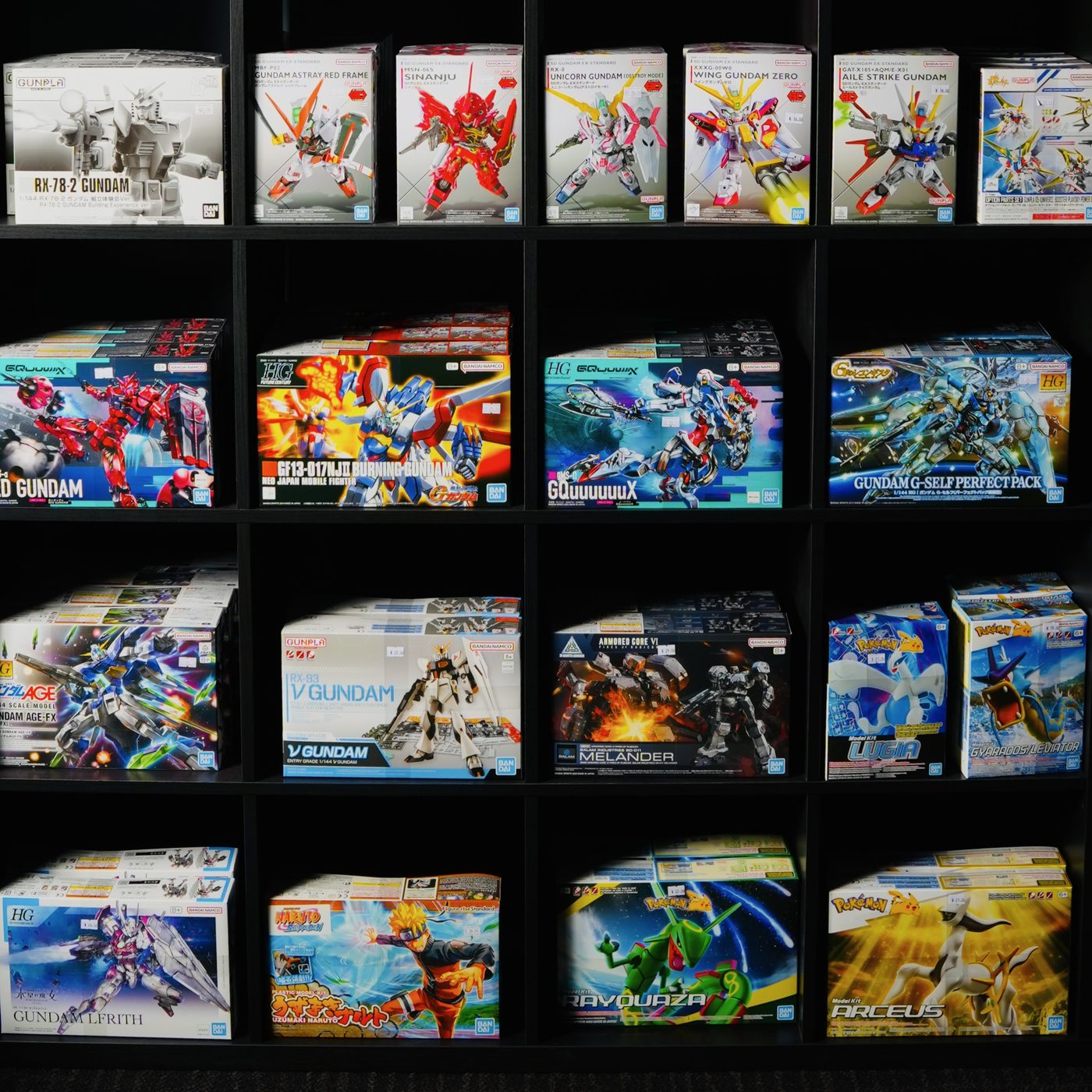 Shelves stocked with Gundam, Pokémon and Naruto model kits